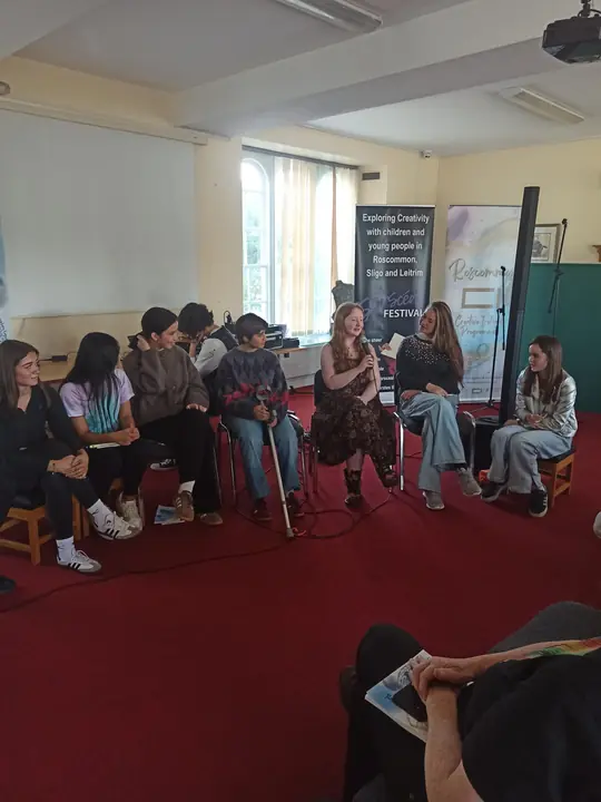 Young writers seated in a circle during a discussion