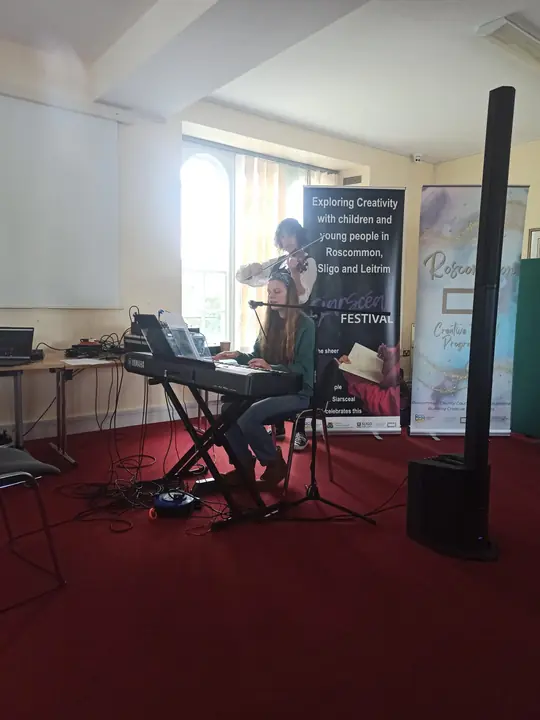 A violinist and keyboard player performing
