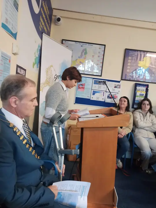 A young writer reading at the lectern