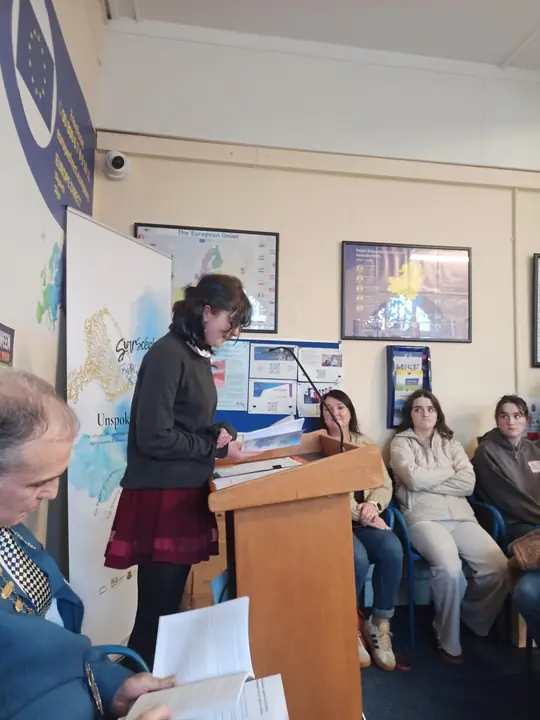 A young writer reading at the lectern