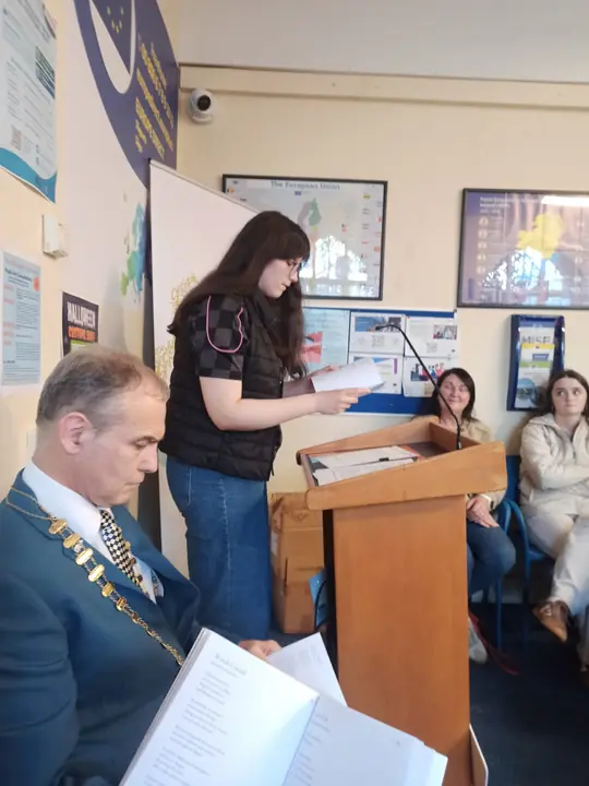 A young writer reading at the lectern