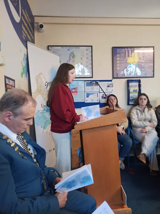 A young writer reading at the lectern
