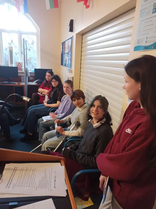 Young writers seated together, listening